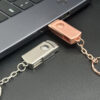 Metal swivel pendrive plugged into laptop USB port, swivel cap rotated open