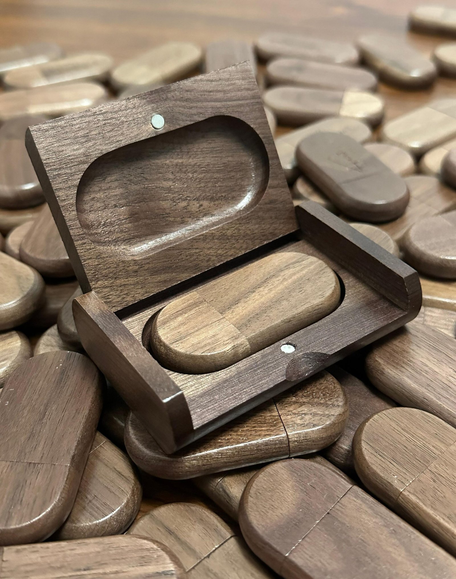 Rounded capsule silhouette of wood USB stick showing sleek curved edges and matte texture