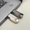 Side view of CZ74 metal USB flash drive highlighting 4mm ultra-slim thickness against fingertip