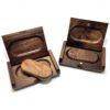 Handcrafted solid walnut wood USB drive with magnetic cap closure, resting on a wooden gift box lid in natural daylight