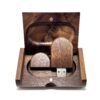 Open wooden gift box revealing a round-edge walnut USB flash drive with visible wood grain