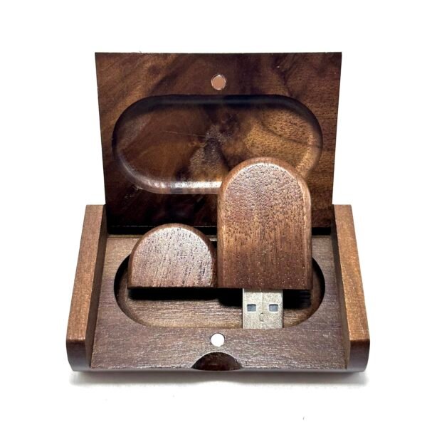 Open wooden gift box revealing a round-edge walnut USB flash drive with visible wood grain